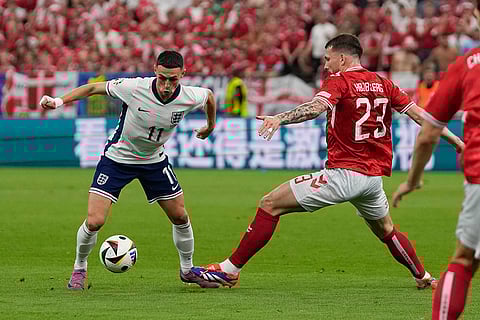 Phil Foden and Pierre-Emile Hojbjerg compete for the ball